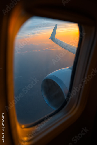 Wing of an airplane in the morning sunrise. Picture for add text message or frame website. Photo taken in the sky.