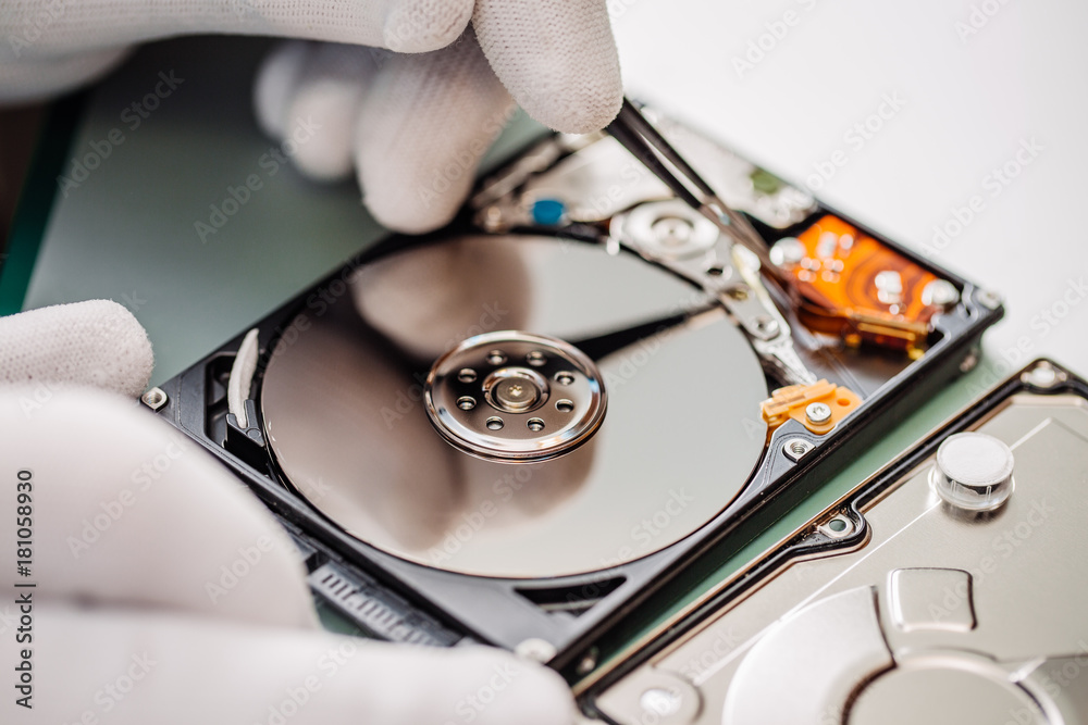 man repairing hard drive in service center. Repairing and fixing service in lab. Electronics repair service concept. man repairing hard drive in service center. Repairing and fixing service in lab. Electronics repair service concept.