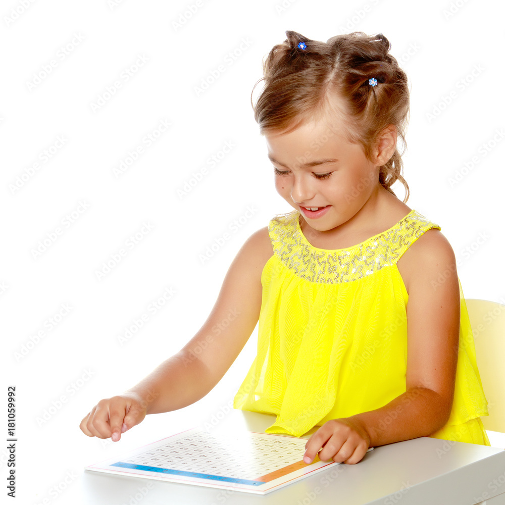 A little girl is studying Montessori stuff. A little girl is studying Montessori stuff.