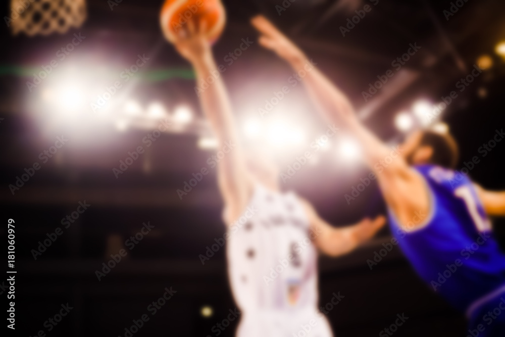 Naklejka premium scoring during a basketball game - ball in hoop - blurred image