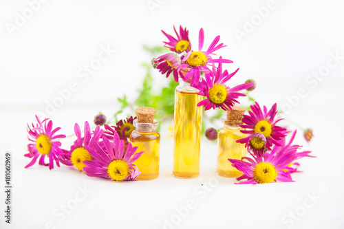 chrysanthemum essential oil in beautiful bottle on White background