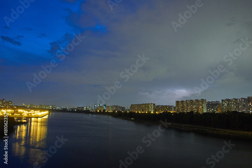 Cityscape at dusk with thunderstorm over apartments buildings © Max Ryazanov