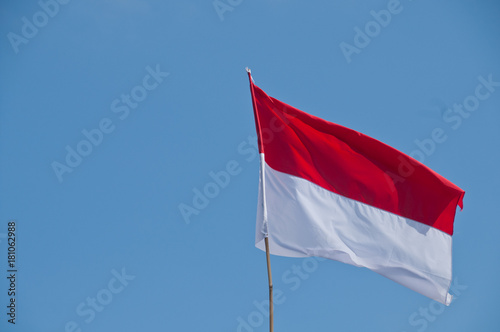 White and Red national flag of Indonesia with blue sky