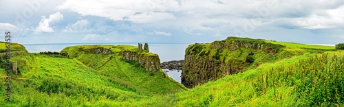Ruins of Dunseverick Castle in Northern Ireland. Landscape of green cliffs on the emerald island. 