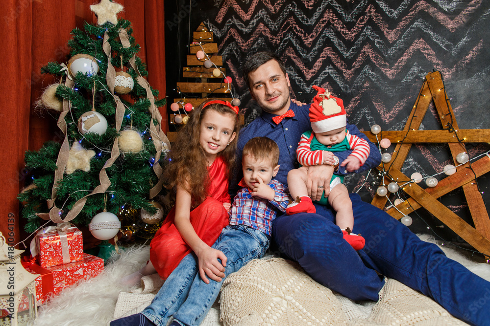 Father with kids in a Christmas photo session Father with kids in a Christmas photo session