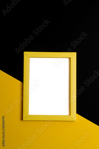 Empty yellow papper frame on colorful background with copy space.