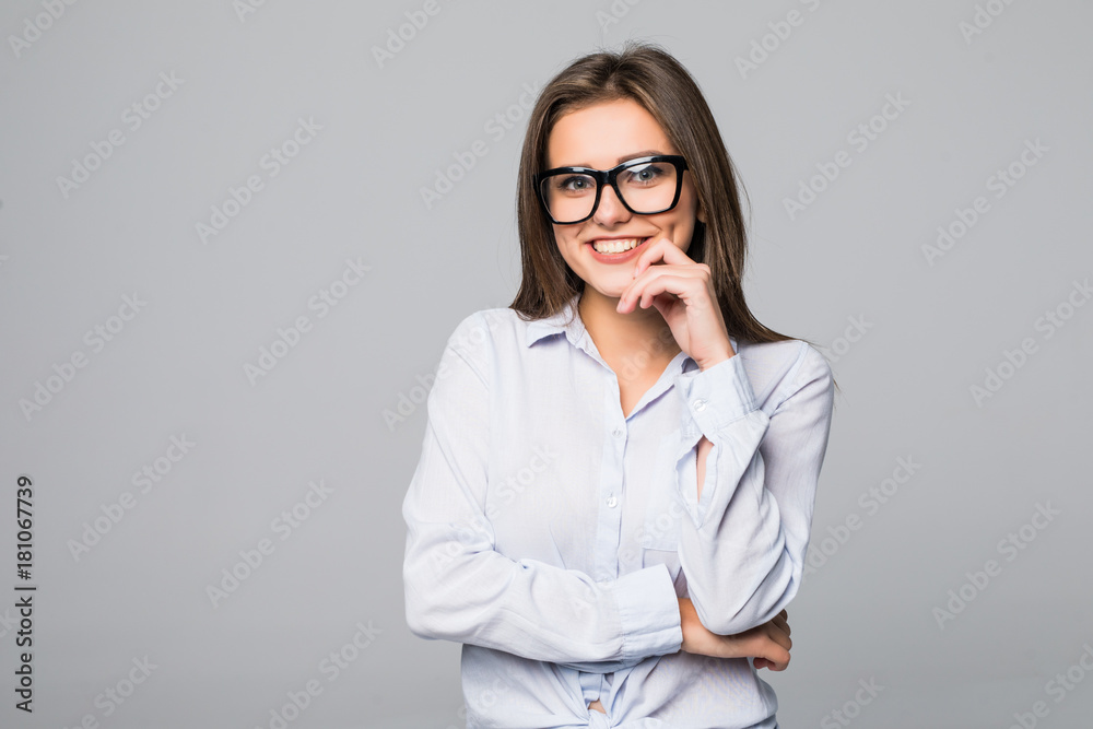 Brunette woman in glasses thinking, studio on gray background Brunette woman in glasses thinking, studio on gray background