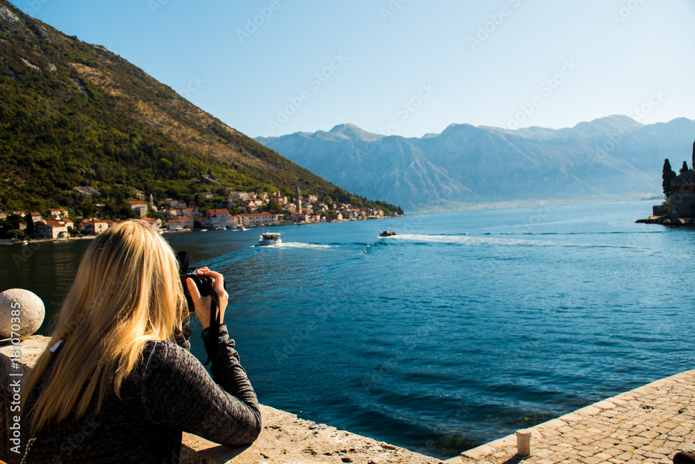 Photographer taking a scenic picture of the sea during a summer day whilst travelling in Europe