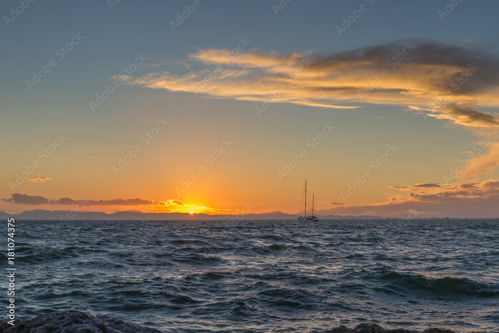 Sailing yacht and sunset in the sea. La Manga. Spain.

