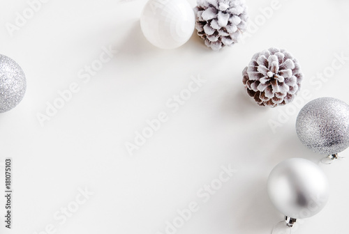 White Christmas background. Frosty pine cones, white colored decoration balls. Minimalist style. Copyspace for text, overhead, horizontal photo