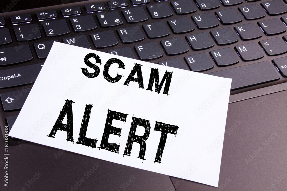 Scam Alert writing text made in the office close-up on laptop computer keyboard. Business concept for Scam Alert on the black background with copy space Scam Alert writing text made in the office close-up on laptop computer keyboard. Business concept for Scam Alert on the black background with copy space