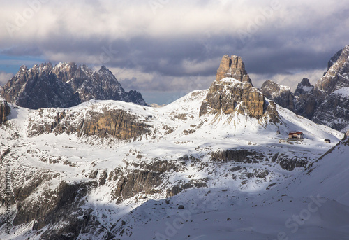 View of the Torre di Toblin peak and the Locatelli hut, in the background the Punta dei Tre Scarperi,Tre Cime Natural Park, Dolomites, Italy photo