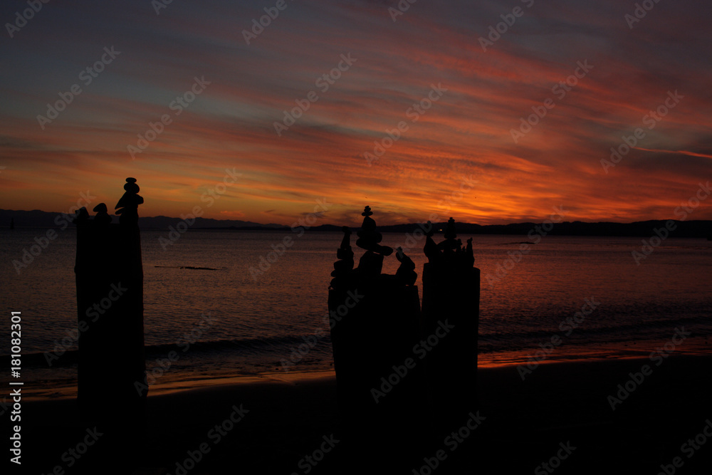 Stacked Stones, or Inukshuk, With a Sunset Back Drop at the Break Water Beach, Victoria, British Columbia, Canada