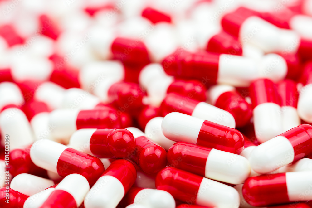 Selective focus of antibiotic capsules pills on blur background with copy space. Drug resistance concept. Antibiotics drug use with reasonable and global healthcare concept. Selective focus of antibiotic capsules pills on blur background with copy space. Drug resistance concept. Antibiotics drug use with reasonable and global healthcare concept.