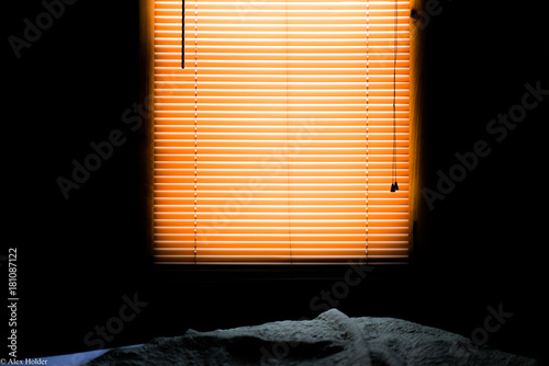 morning light through drawn blinds 