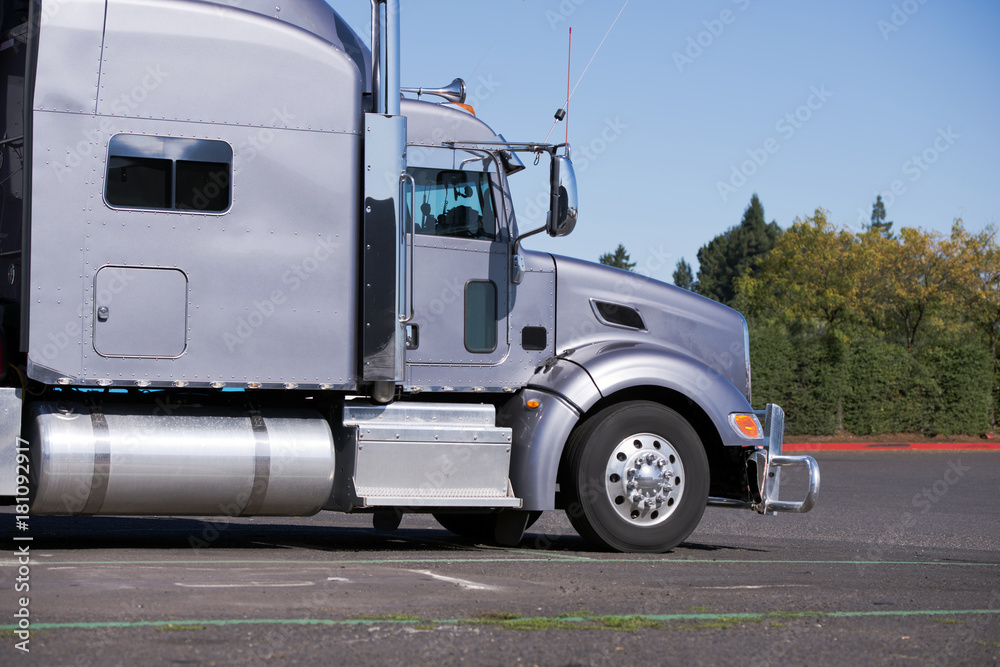 Profile of Big rig gray classic semi truck tractor going to delivery commercial cargo