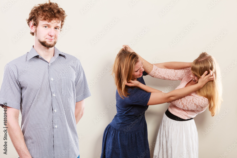 Aggressive mad women fighting over man. Aggressive mad women fighting over man.