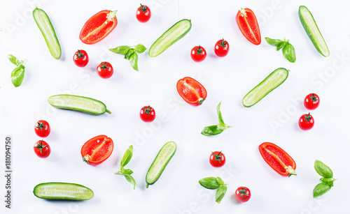 Fresh food pattern with cucumbers, peppers, tomatoes and herbs.