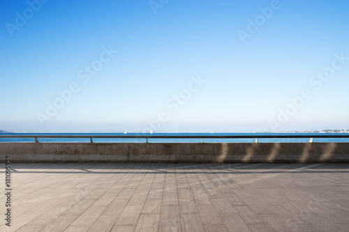 empty marble floor with blue sea in blue sky