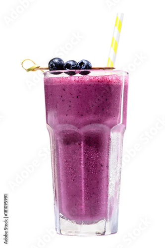 High glass filled with  fresh delicious dieting blueberry and blackberry fresh fruit smoothie with yellow straw, decorated with berries, isolated on white background