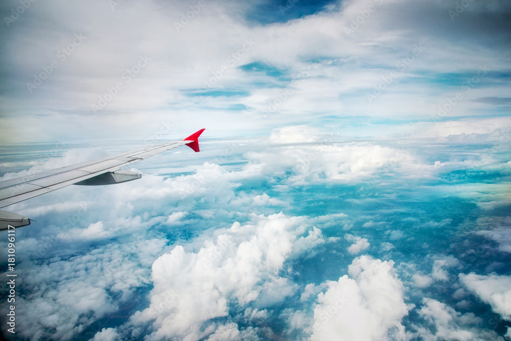 Wing of an airplane flying above white clouds. Wing of an airplane flying above white clouds.