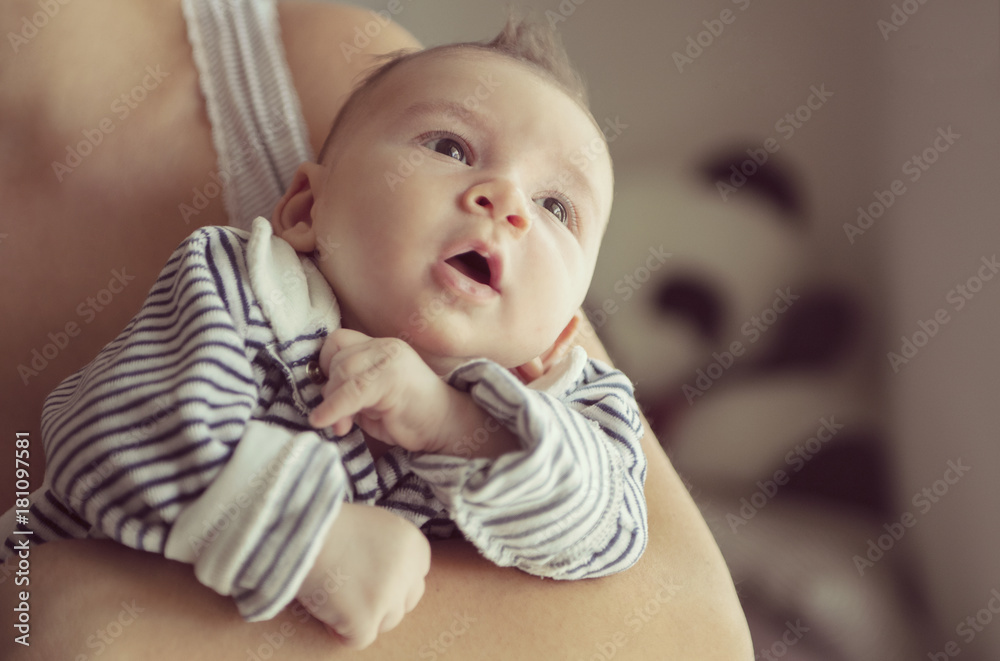 Newborn baby lying in her mother's arms Newborn baby lying in her mother's arms