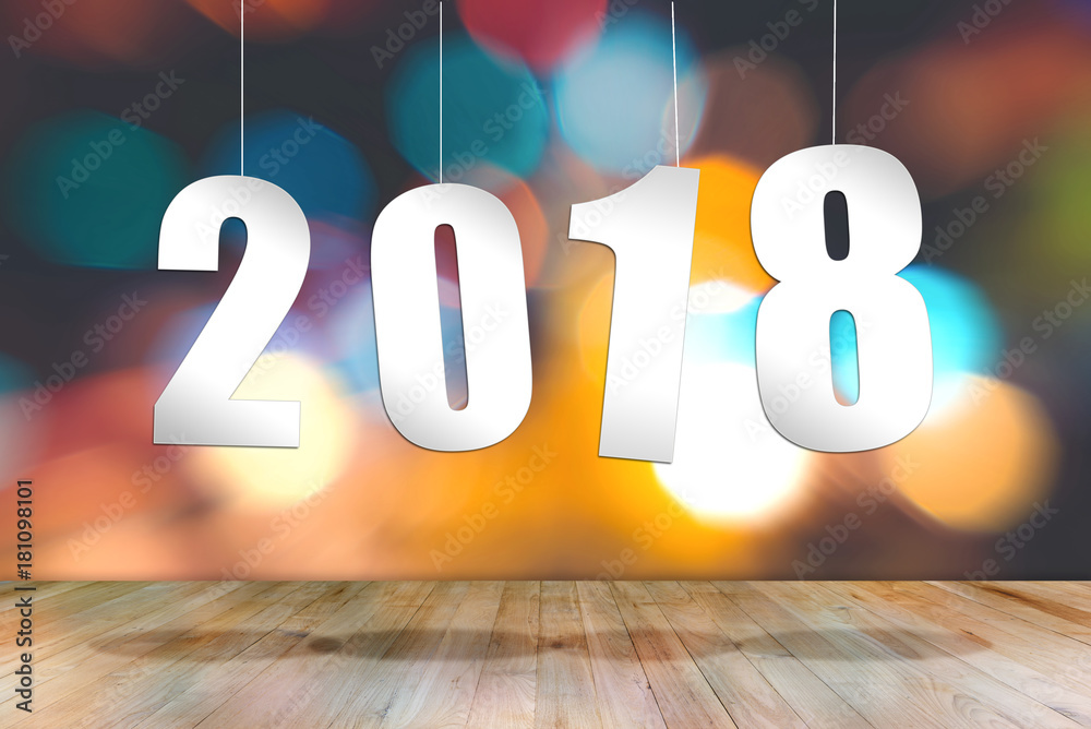 2018 text number hanging above empty wood table with bokeh light background. New year holiday concept. 2018 text number hanging above empty wood table with bokeh light background. New year holiday concept.