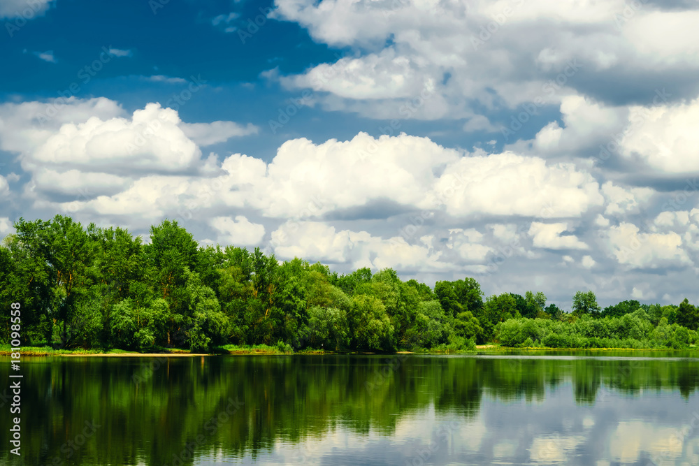 Beautiful summer rural landscape with river and clouds on the blue sky. Russia. Ural. Village Sloboda