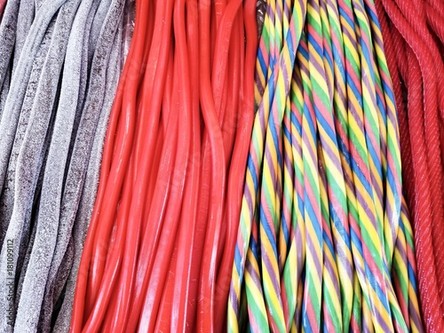 background of rainbow twisted candy. colorful twisted licorice candy, texture