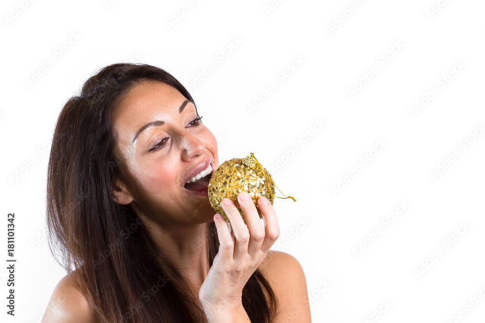 Portrait of beautiful girl want to eat a christmas ball. Portrait of beautiful girl want to eat a christmas ball.