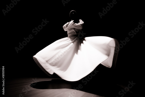 the image of a whirling Dervish in the darkness photo