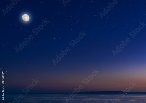 Moon and stars over the calm sea. © volff