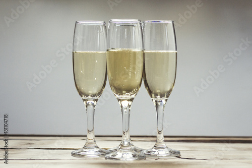 Three glasses of champagne on a wooden table