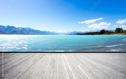 empty brick floor with beautiful sea by snow mountains