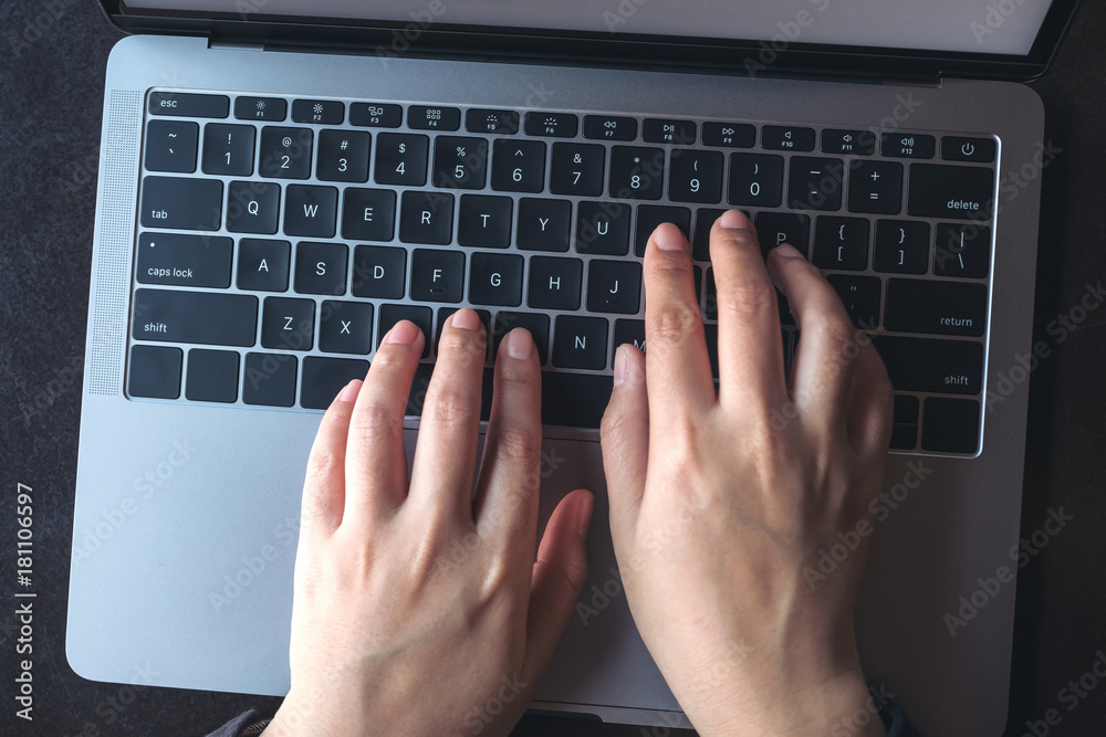 Top view image of business woman's hands typing on laptop on vintage wooden table Top view image of business woman's hands typing on laptop on vintage wooden table