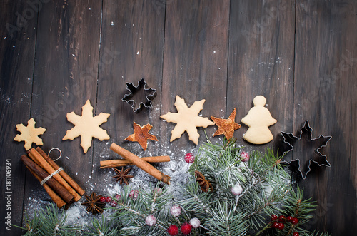 Christmas fir branches, coocies,  spice on wooden background. photo