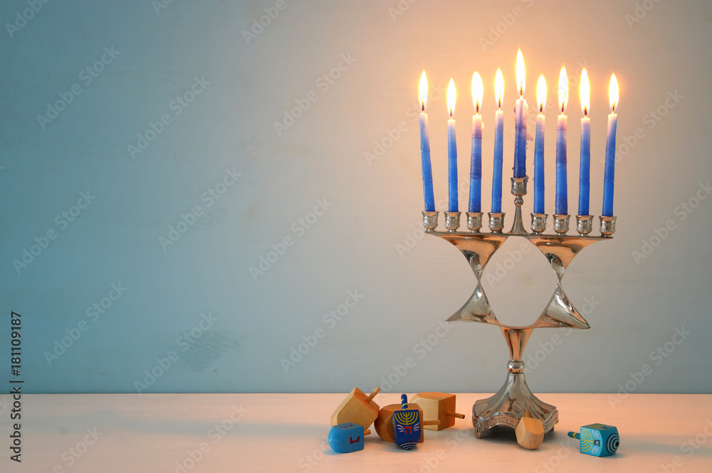 image of jewish holiday Hanukkah background with menorah (traditional candelabra) and candles. image of jewish holiday Hanukkah background with menorah (traditional candelabra) and candles.