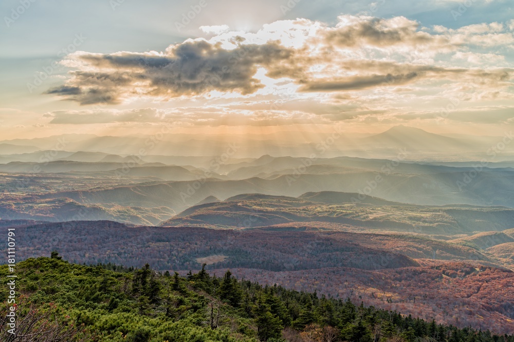 Fototapeta premium Sun ray over the mountain range at Hakkoda area in autumn season, Aomori, Japan.