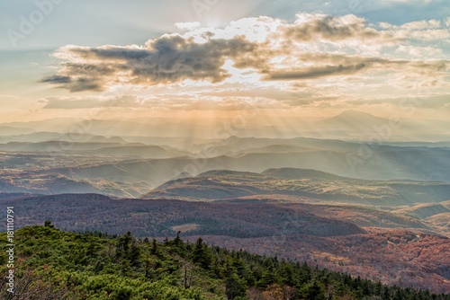 Sun ray over the mountain range at Hakkoda area in autumn season, Aomori, Japan. photo