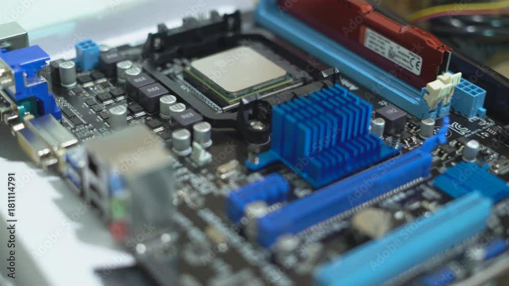 a man in blue latex gloves collects chips. production of modern computers. the hands of a person set the ditali. 4K a man in blue latex gloves collects chips. production of modern computers. the hands of a person set the ditali. 4K