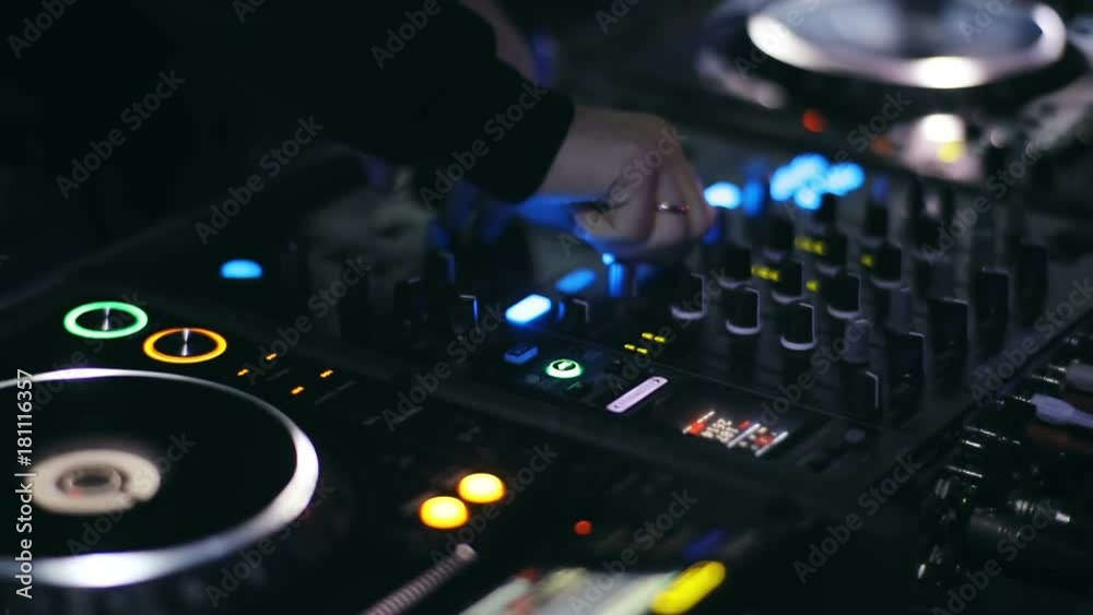 LVIV,UKRAINE - 2017: DJ playing music deejaj mixing sounds closeup close-up view night lifestyle youth club concert techno electro deep hause music stereo hands volume clubbing entertainment record