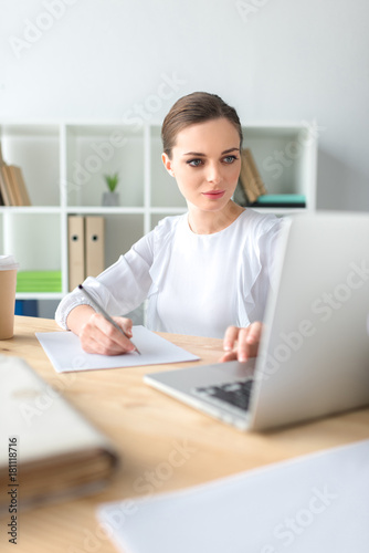 Businesswoman looking at laptop