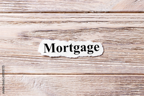 mortgage of the word on paper. concept. Words of mortgage on a wooden background photo