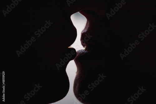 Guy and girl kiss large lips lips silhouettes. The guy is kissing the girl. photo