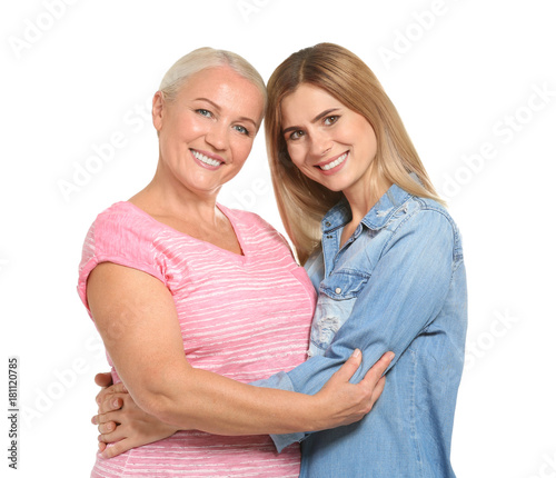 Young woman hugging elderly...