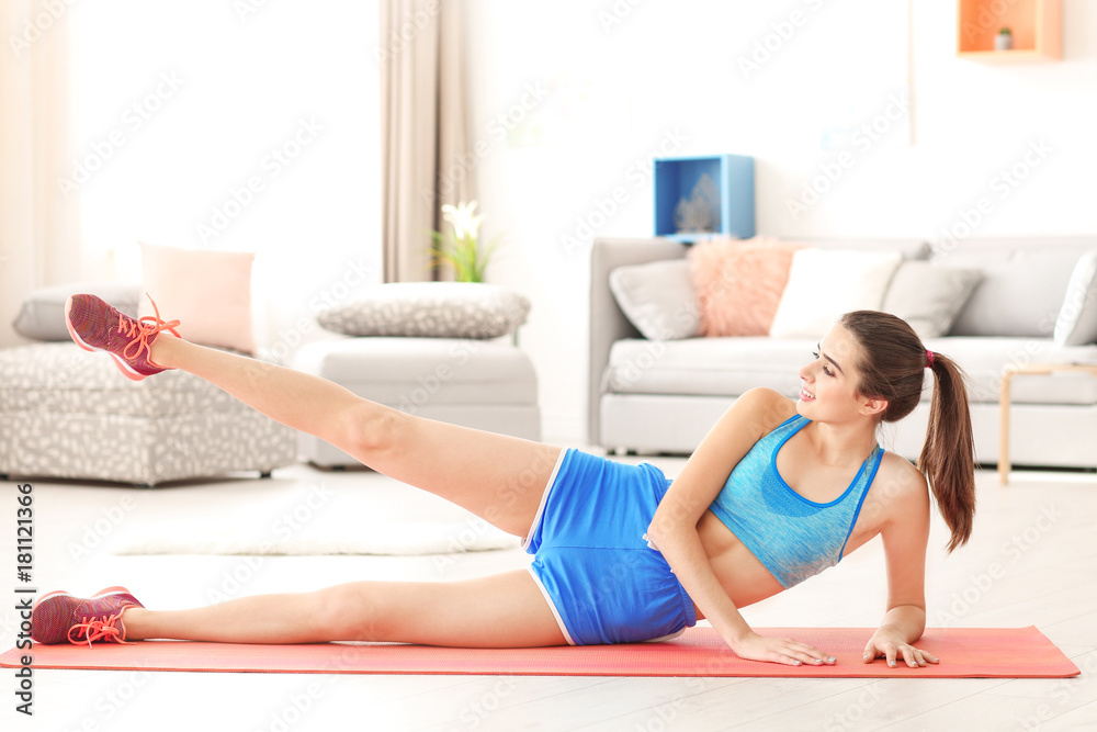 Beautiful young woman doing exercises at home Beautiful young woman doing exercises at home