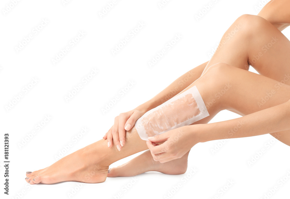Beautiful woman waxing her legs, isolated on white Beautiful woman waxing her legs, isolated on white