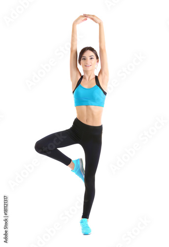 Beautiful young woman doing exercises, isolated on white