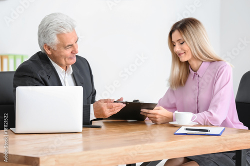 Young woman consulting elde...