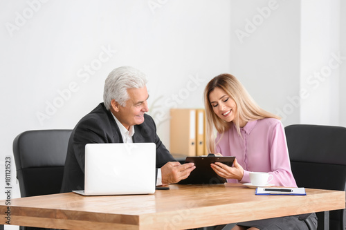 Young woman consulting elde...